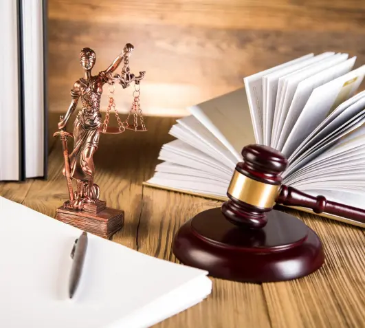 Lady of justice, gavel and books on wooden table